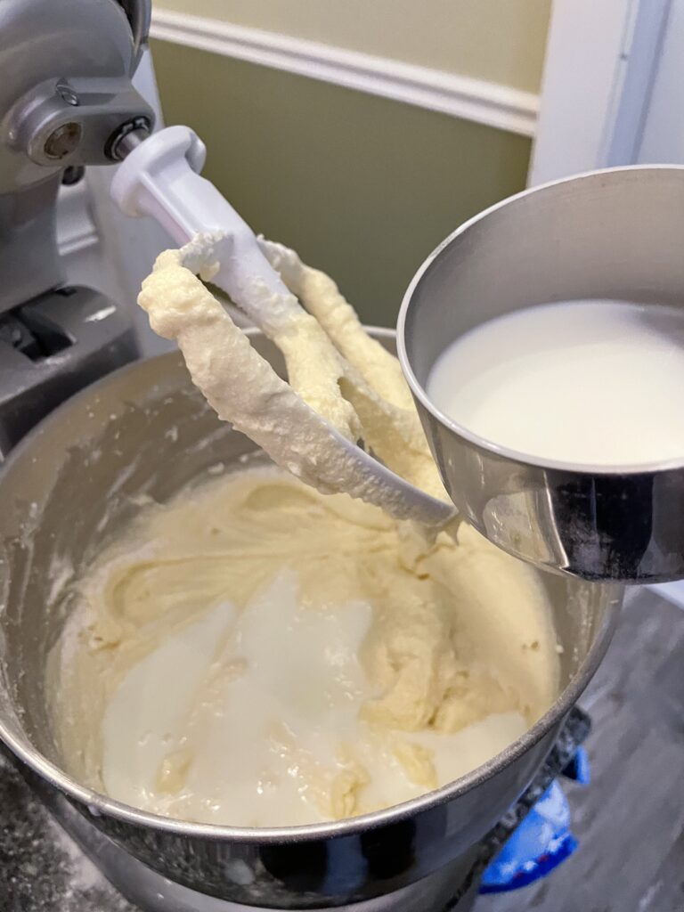 milk in a measuring cup being added to the mix