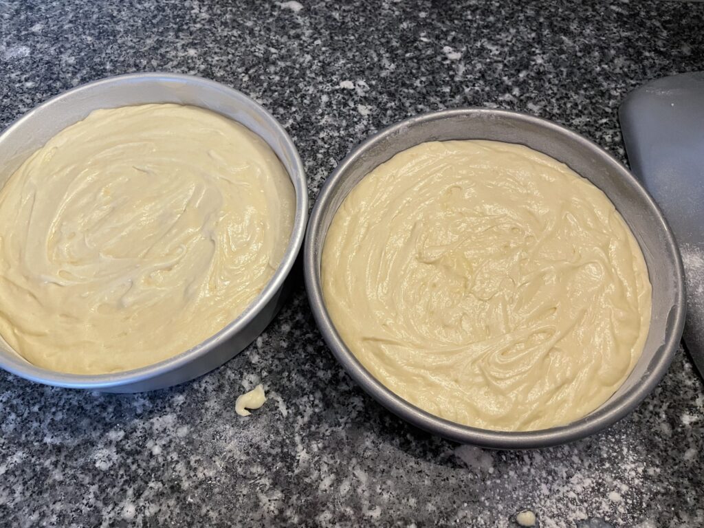 cake batter evenly divided between the two pans